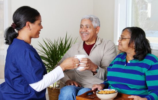 Home Health Care Home health care worker and an elderly couple