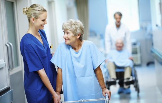 Happy nurse and doctor assisting a woman and man with a walker and wheelchair